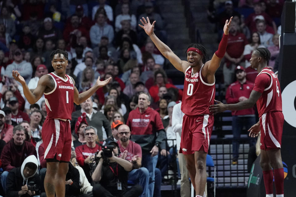 Arkansas guards JD Notae (1), Stanley Umude (0) and Davonte Davis (4) react to an official's call in the second half of an NCAA college basketball game against Oklahoma, Saturday, Dec. 11, 2021, in Tulsa, Okla. (AP Photo/Sue Ogrocki)