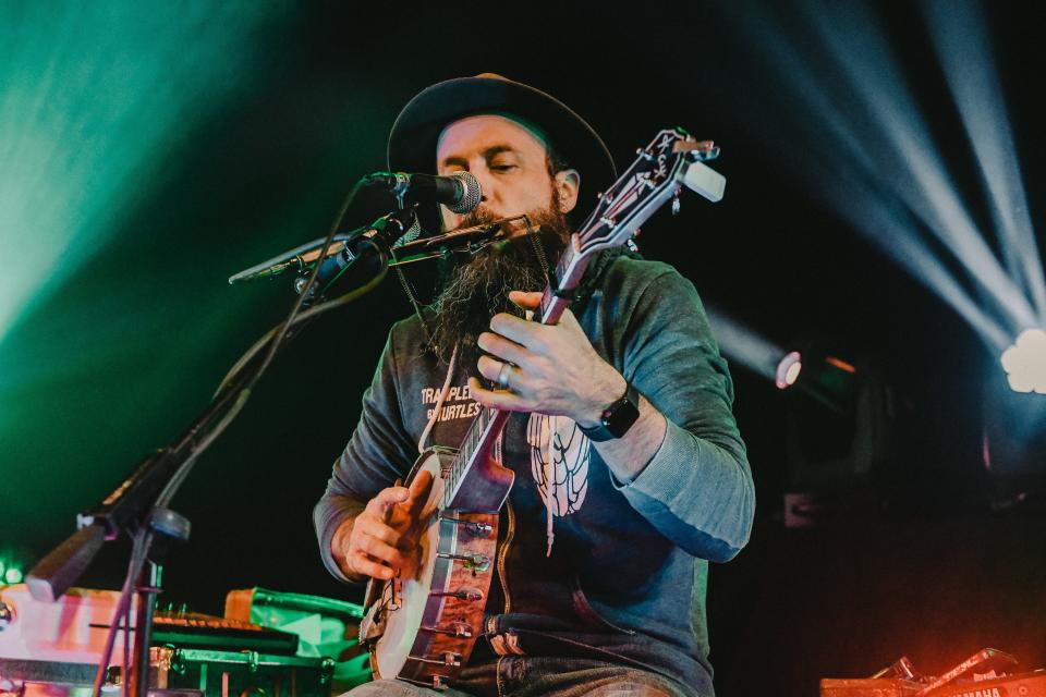 MK Ultra member Pat Kay strums his banjo during a 2021 show at The Blue Note.