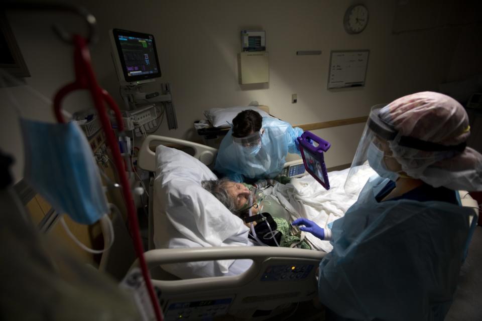 Nurse Gloria Franklin holds the iPad up to patient Margaret Gallegos-Capetello