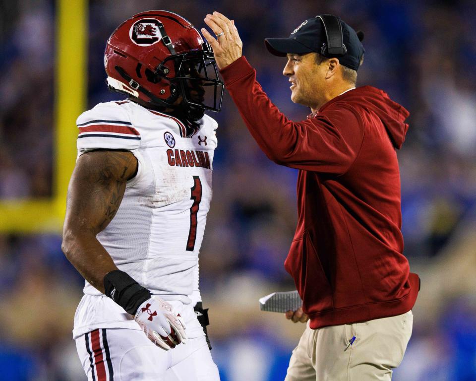 Oct 8, 2022; Lexington, Kentucky; South Carolina Gamecocks head coach Shane Beamer celebrates with running back MarShawn Lloyd (1) during the third quarter against the Kentucky Wildcats at Kroger Field. Jordan Prather-USA TODAY Sports