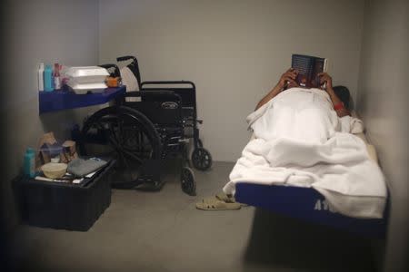 An ICE detainee lies in his cell in the segregation wing at the Adelanto immigration detention center, which is run by the Geo Group Inc (GEO.N), in Adelanto, California, U.S., April 13, 2017. REUTERS/Lucy Nicholson