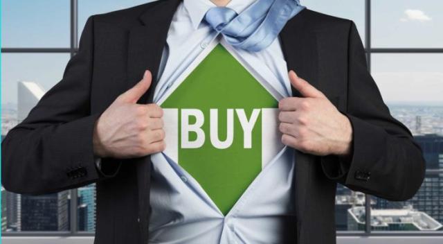 A businessman ripping his shirt off to reveal an upward green arrow with the word buy on it underneath