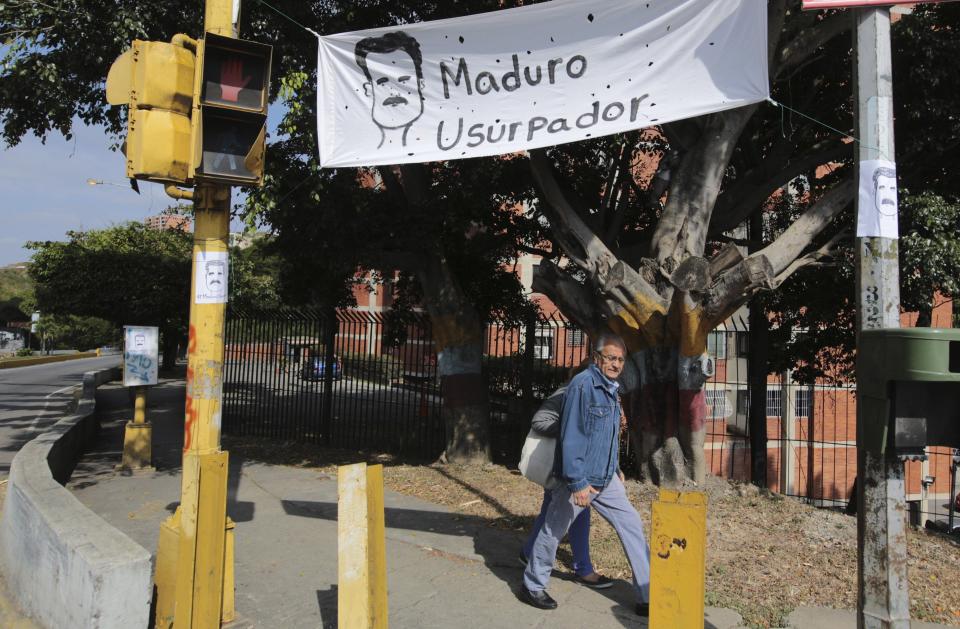 A protest sign that reads in Spanish "Maduro usurper" hangs on the day Venezuelan President Nicolas Maduro is sworn in for a second term in Caracas, Venezuela, Thursday, Jan. 10, 2019. Maduro's second, six-year term starts amid international calls for him to step down and a devastating economic crisis. (AP Photo/Fernando Llano)