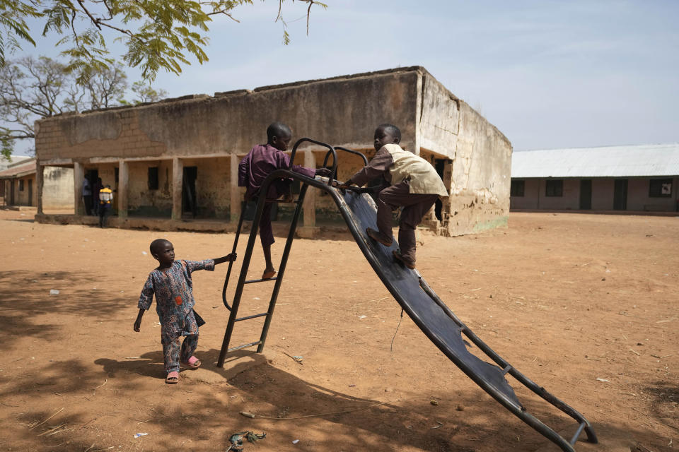 Children play at the LEA Primary and Secondary School Kuriga were students were kidnapped in Kuriga, in Kaduna state, Nigeria, Saturday, March 9, 2024. Security forces swept through large forests in Nigeria's northwest region on Friday in search of nearly 300 children who were abducted from their school a day earlier in the West African nation's latest mass kidnap which analysts and activists blamed on the failure of intelligence and slow security response. (AP Photo/Sunday Alamba)