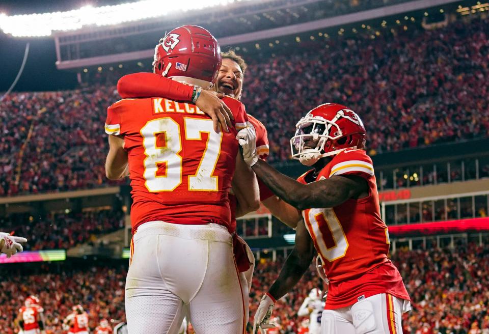 Kansas City Chiefs tight end Travis Kelce celebrates the game-winning touchdown with quarterback Patrick Mahomes (15) against the Buffalo Bills in their divisional-round game.