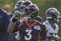 Denver Broncos quarterback Russell Wilson drinks during a practice session in Harrow, England, Wednesday, Oct. 26, 2022 ahead the NFL game against Jacksonville Jaguars at the Wembley stadium on Sunday. (AP Photo/Kin Cheung)