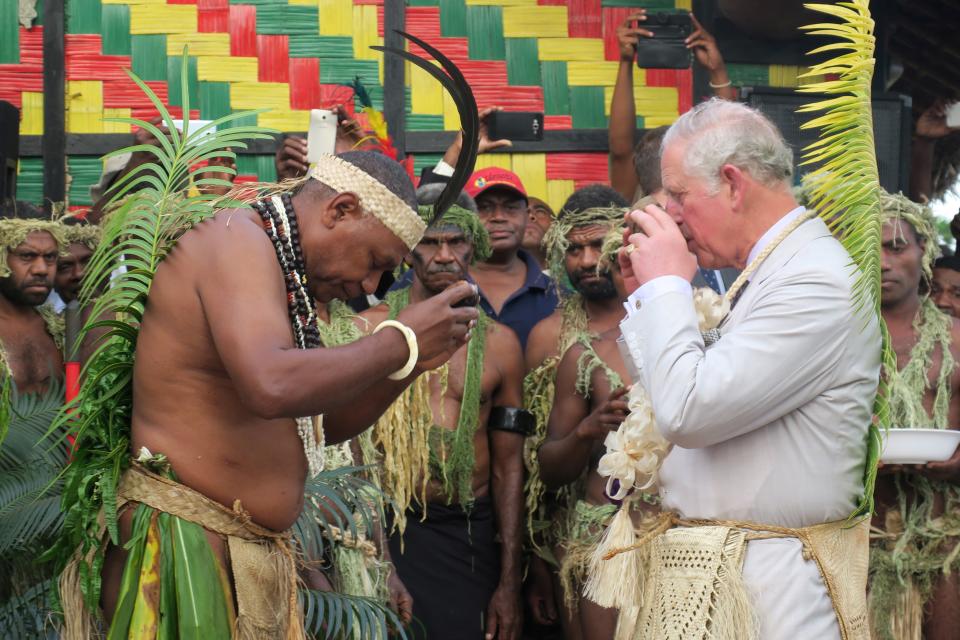 Britain's Prince Charles (R) drinks kava with Chief Seni Mao Tirsupe, the President of the Malvatumauri Council of Chiefs, to the Chiefs Nakamal in Port Vila on April 7, 2018.            / AFP PHOTO / Ben BOHANE        (Photo credit should read BEN BOHANE/AFP via Getty Images)