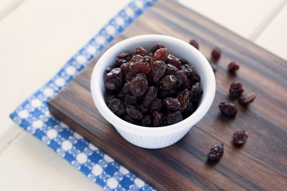 raisins in bowl on cutting board