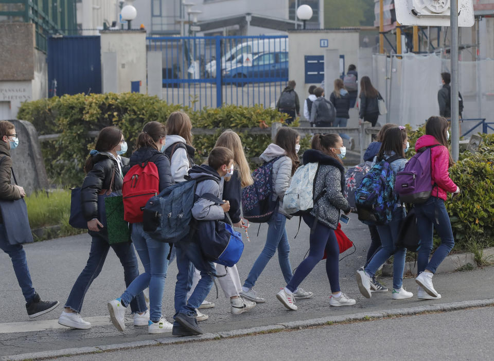 Students arrive at school in Le Chesnay, west of Paris, Modnay, May 3, 2021. Students go back to secondary and high schools and a domestic travel ban will end. The French government is slowly starting to lift partial lockdowns, despite still high numbers of coronavirus cases and hospitalized COVID-19 patients. (AP Photo/Michel Euler)