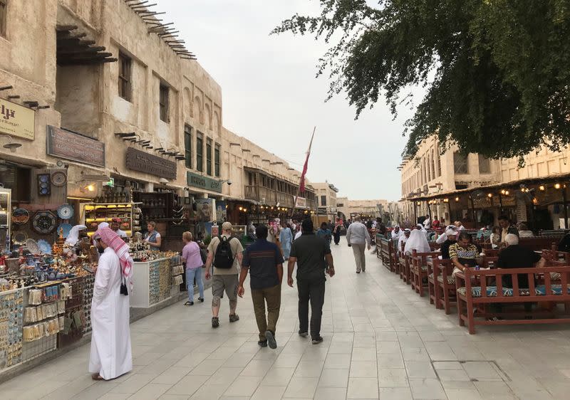 People walk at souq Waqif, following the outbreak of coronavirus, in Doha