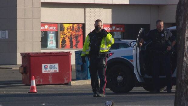 A member of the Regina Police Service is seen wearing a mask in a CBC file photo. The Saskatchewan Association of Chiefs of Police says front-line officers should be considered for priority as the province continues its vaccine rollout, considering they're regularly dealing with COVID-19 enforcement measures. (CBC - image credit)