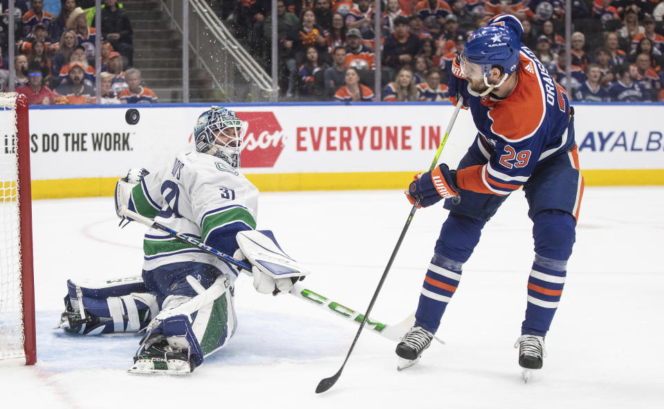 Vancouver Canucks goalie Arturs Silovs (31) makes the save on Edmonton Oilers' Leon Draisaitl (29) during the second period of Game 3 of an NHL hockey Stanley Cup second-round playoff series in Edmonton, Alberta, Sunday, May 12, 2024. (Jason Franson/The Canadian Press via AP)