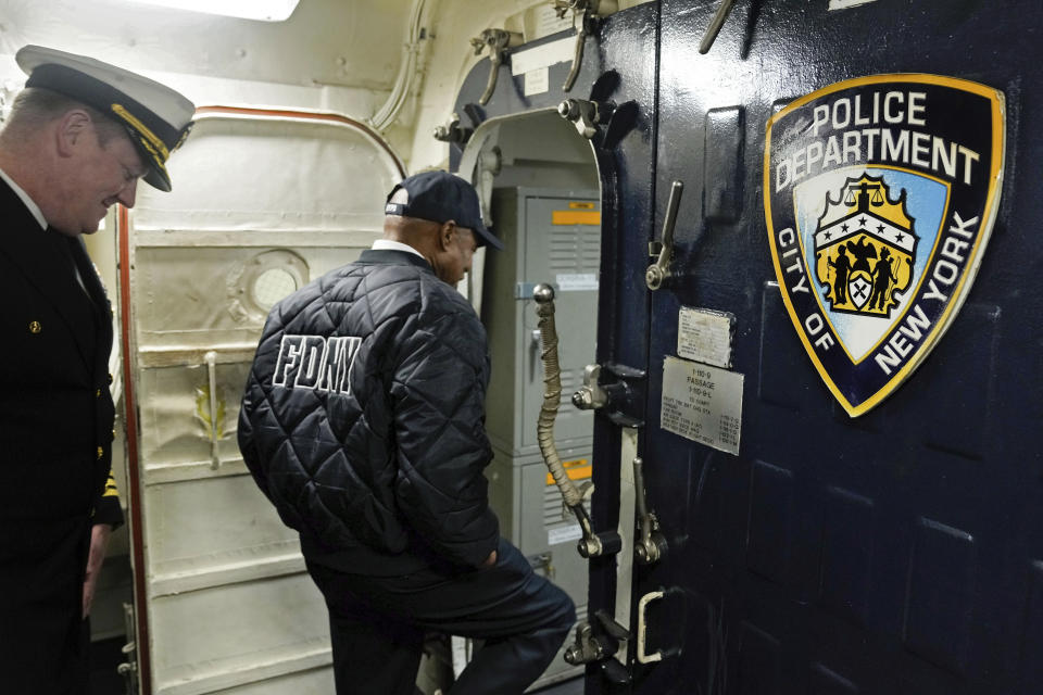 This photo, released by Office of the New York Mayor, shows New York Mayor Eric Adams during his visit to the U.S. Navy ship USS New York, accompanied by Capt. Benjamin Oakes, left, the day before Veterans Day, in New York, Friday, Nov. 10, 2023. FBI agents seized phones and an iPad from Adams this week as part of an investigation into his campaign finances, according to a published report, Friday, Nov. 10, 2023.(Michael Appleton/Mayoral Photography Office via AP)