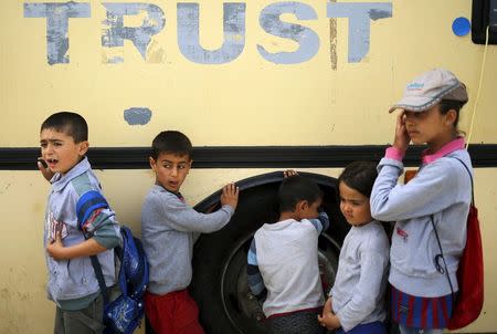 Children queue for food at a makeshift camp for migrants and refugees at the Greek-Macedonian border near the village of Idomeni, Greece, April 19, 2016. REUTERS/Stoyan Nenov