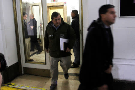 Chilean police officers are seen during the confiscation of the documents inside the office of the Ecclesiastical Court of the archdiocese of Santiago, Chile June 13, 2018. REUTERS/Marcelo Hernandez