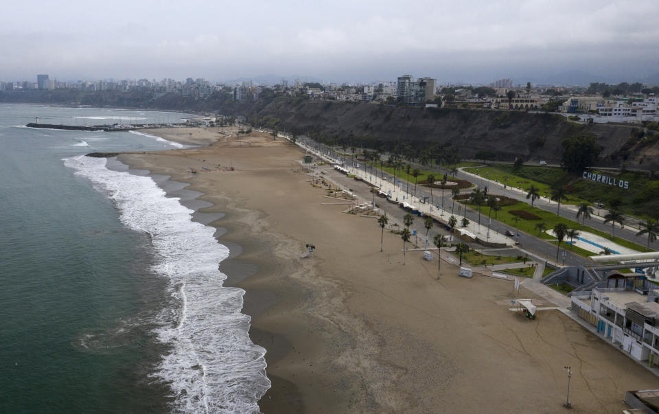 This March 25, 2020 photo shows an aerial view of Agua Dulce beach absent of beachgoers in the final days of the Southern Hemisphere summer, in Lima, Peru. (AP Photo/Rodrigo Abd)