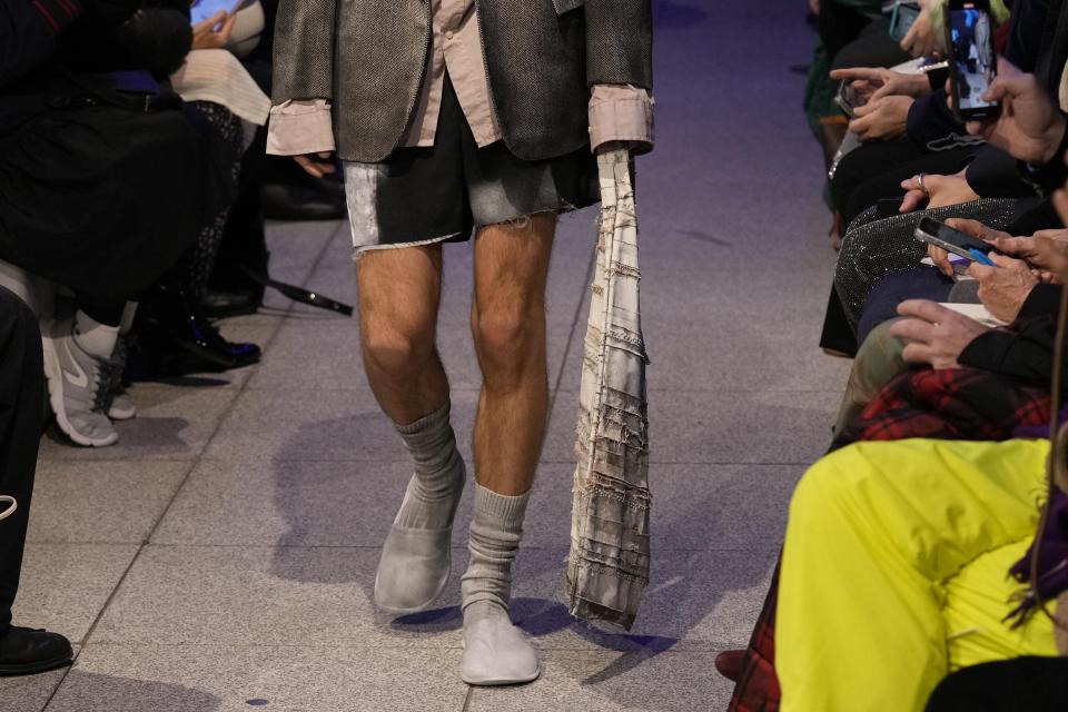 A model wears a creation part of the men's Simon Cracker Fall-Winter 2024-2025 collection, that was presented in Milan, Italy, Sunday, Jan. 14, 2024. (AP Photo/Antonio Calanni).