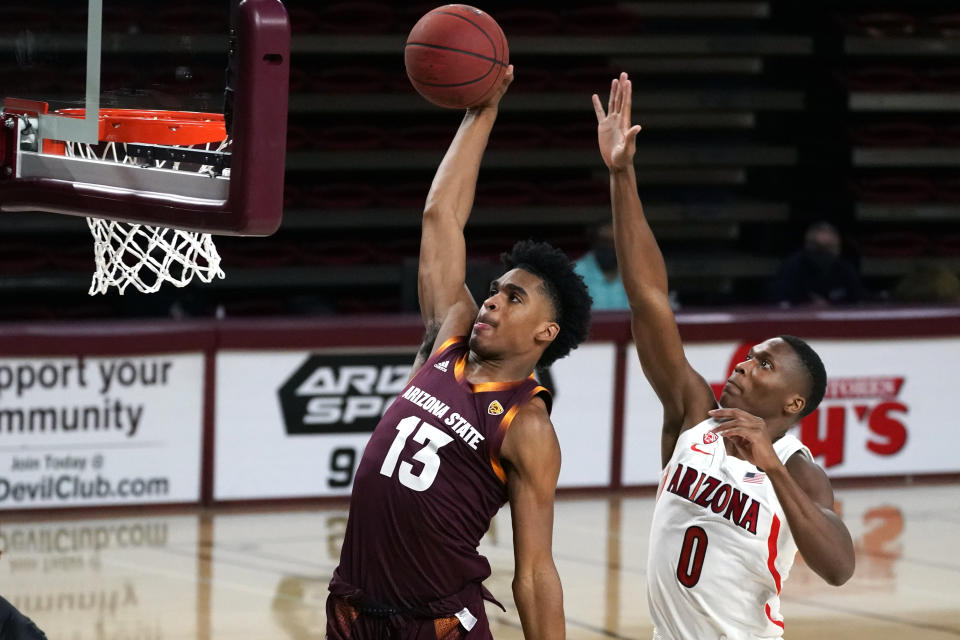 Arizona State guard Josh Christopher (13) dunks in front of Arizona guard Bennedict Mathurin during the first half of an NCAA college basketball game Thursday, Jan. 21, 2021, in Tempe, Ariz. (AP Photo/Rick Scuteri)