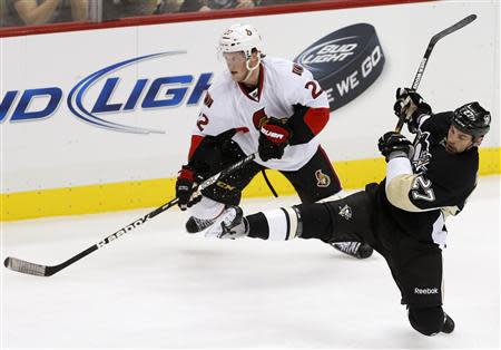 Pittsburgh Penguins Craig Adams (27) loses his footing against Ottawa Senators Erik Condra (22) in the second period of their NHL hockey game in Pittsburgh, Pennsylvania, February 13, 2013. REUTERS/Jason Cohn