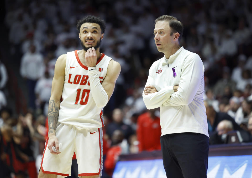 FILE - New Mexico Head coach Richard Pitino talks to his starting guard Jaelen House during the second half of an NCAA college basketball game, Saturday, Feb. 10, 2024, in Albuquerque, N.M. Pitino said. "The better everybody's doing with NET rankings and KenPom and all those things, it just helps it. It'll be fun to see how it all plays out and it will certainly make for an amazing Mountain West tournament." (AP Photo/Eric Draper, File)