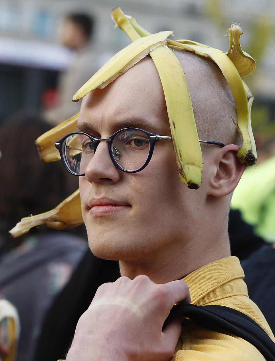 A man with bananas demonstrates with others outside Warsaw's National Museum, Poland, Monday, April 29, 2019, to protest against what they call censorship, after authorities removed an artwork at the museum featuring the fruit, saying it was improper. (AP Photo/Czarek Sokolowski)