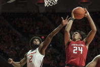 Rutgers' Ron Harper, Jr (24) puts up a shot as Illinois' Kipper Nichols (2) defends in the second half of an NCAA college basketball game, Sunday, Jan. 11, 2020, in Champaign, Ill. (AP Photo/Holly Hart)