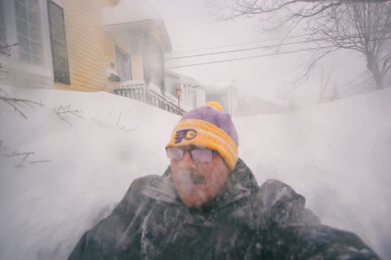 A man is pictured in a snowy street in St. John's, Newfoundland and Labrador