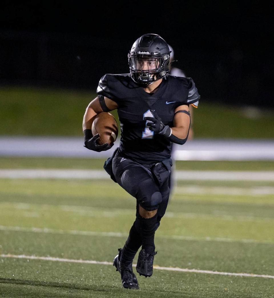 Archbishop Carroll Bulldogs running back Alejandro Isaza (1) runs with the ball against the Westminster Christian Warriors during the first quarter of a high school football game at Tropical Park on Friday, Oct. 21, 2022, in Miami, Fla.