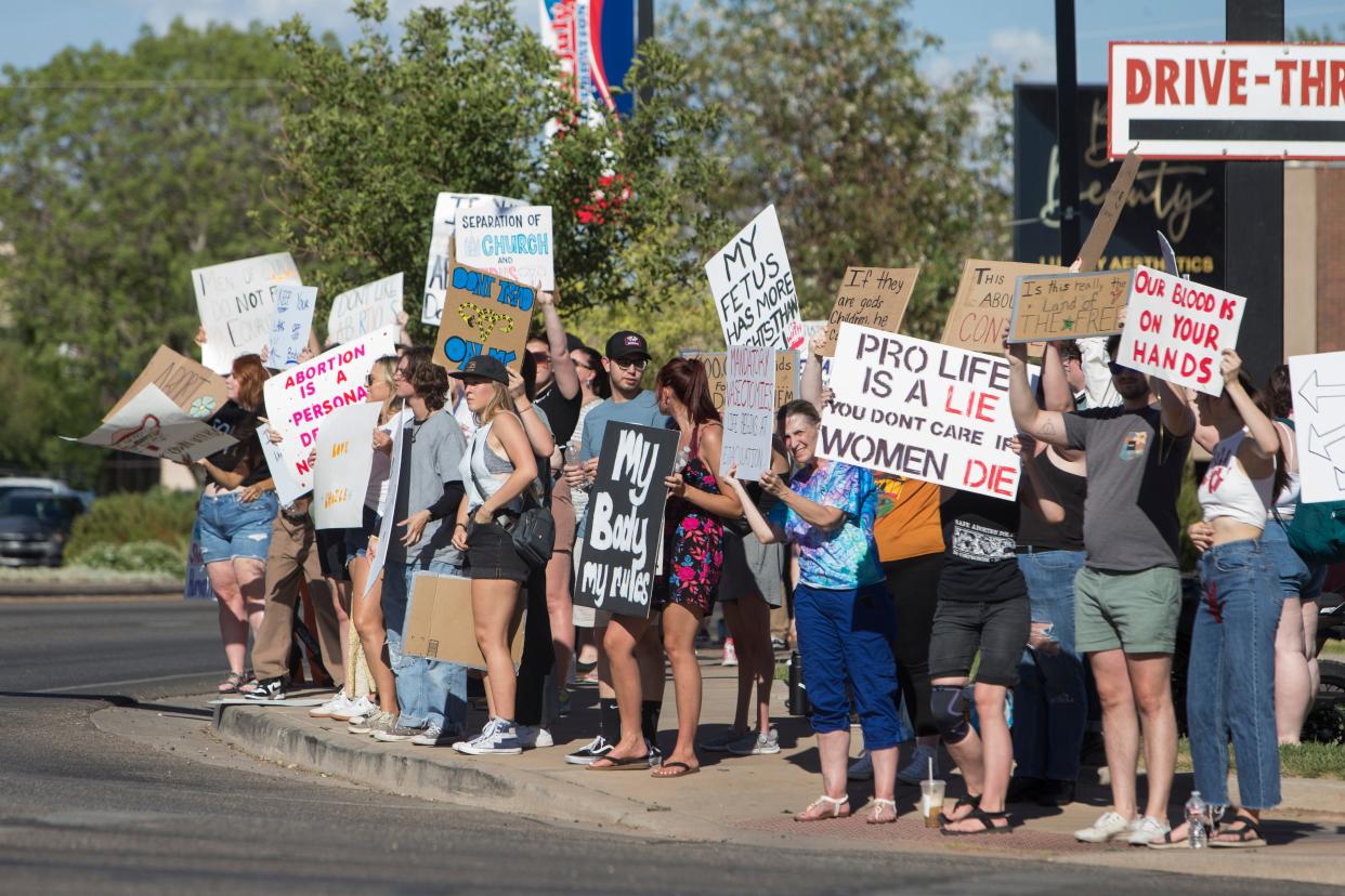 St. George residents protest the recent overturning of Roe v. Wade on St. George Blvd Friday, July 1, 2022. 