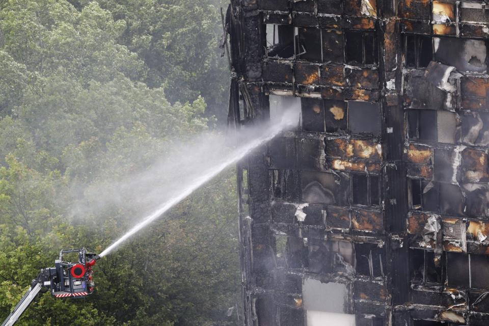 An automated hose sprays water onto Grenfell Tower, a residential tower block in west London that was caught in a huge blaze on June 15, 2017: AFP/Getty Images