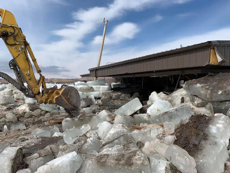 Debris and a damaged building is seen after a storm triggered historic flooding in Niobrara, Nebraska, U.S. March 16, 2019. Office of Governor Pete Ricketts/Handout via REUTERS