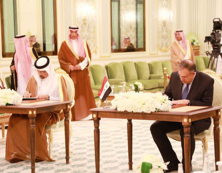 Saudi Energy Minister Khalid al-Falih and Iraqi Minister of Electricity Louay Al Khateeb sign documents in Riyadh, Saudi Arabia April 17, 2019. Iraqi Prime Minister Media Office/Handout via REUTERS