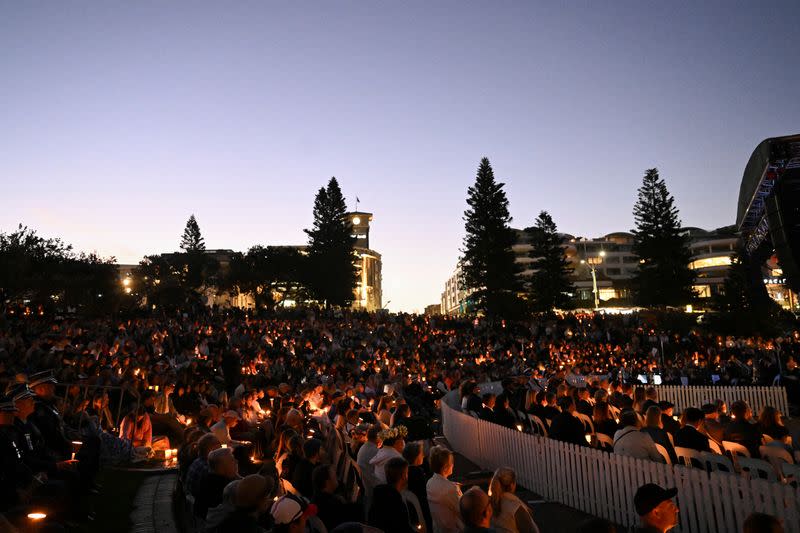 People gather for a candlelight vigil on Bondi Beach to pay respects to the victims of a fatal stabbing attack at a shopping centre in Sydney