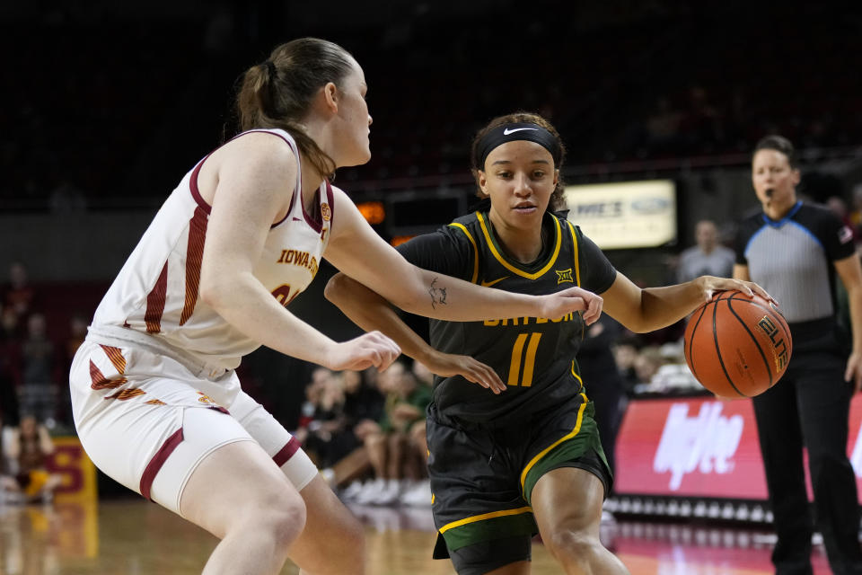 Baylor guard Jada Walker (11) drives past Iowa State forward Addy Brown, left, during the first half of an NCAA college basketball game, Saturday, Jan. 13, 2024, in Ames, Iowa. (AP Photo/Charlie Neibergall)