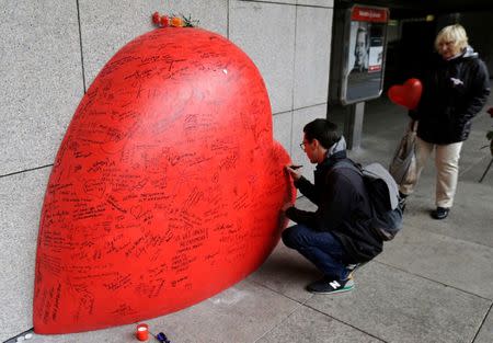 A man writes a message on a memorial to late Czech Republic's President Vaclav Havel on the occasion of the 80th anniversary of his birth in Prague, Czech Republic October 5, 2016. REUTERS/David W Cerny