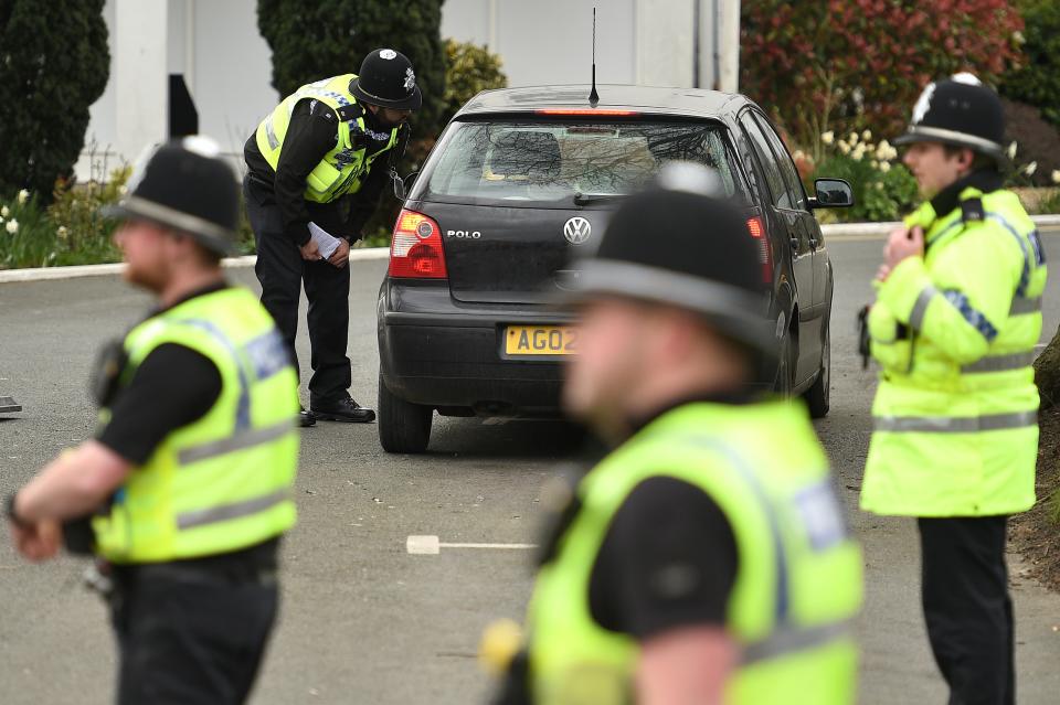 Police officers from North Yorkshire Police stop motorists in cars to check that their travel is "essential", in line with the British Government's Covid-19 advice to "Stay at Home", in York, northern England on March 30, 2020, as life in Britain continues during the nationwide lockdown to combat the novel coronavirus pandemic. - Life in locked-down Britain may not return to normal for six months or longer as it battles the coronavirus outbreak, a top health official warned on Sunday, as the death toll reached passed 1,200. (Photo by Oli SCARFF / AFP) (Photo by OLI SCARFF/AFP via Getty Images)