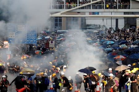 FILE PHOTO - Protesters react after tear gas was fired by the police during a demonstration in support of the city-wide strike and to call for democratic reforms outside Central Government Complex in Hong Kong