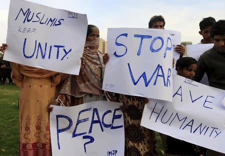 Members of International Movement for Justice and Peace (IMJP) hold placards demanding peace in Yemen during a demonstration in Islamabad March 30, 2015. REUTERS/Faisal Mahmood