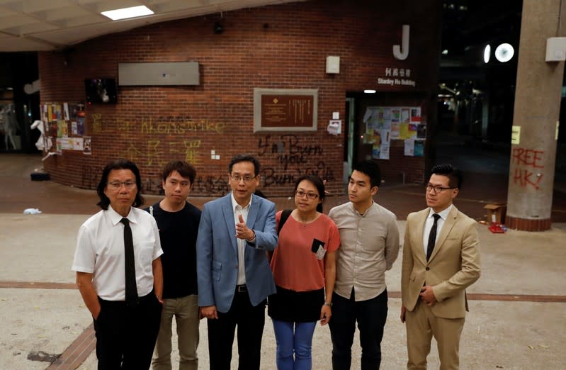 Pro-democratic lawmakers talk to the media after meeting with protesters at the Polytechnic University (PolyU) in Hong Kong