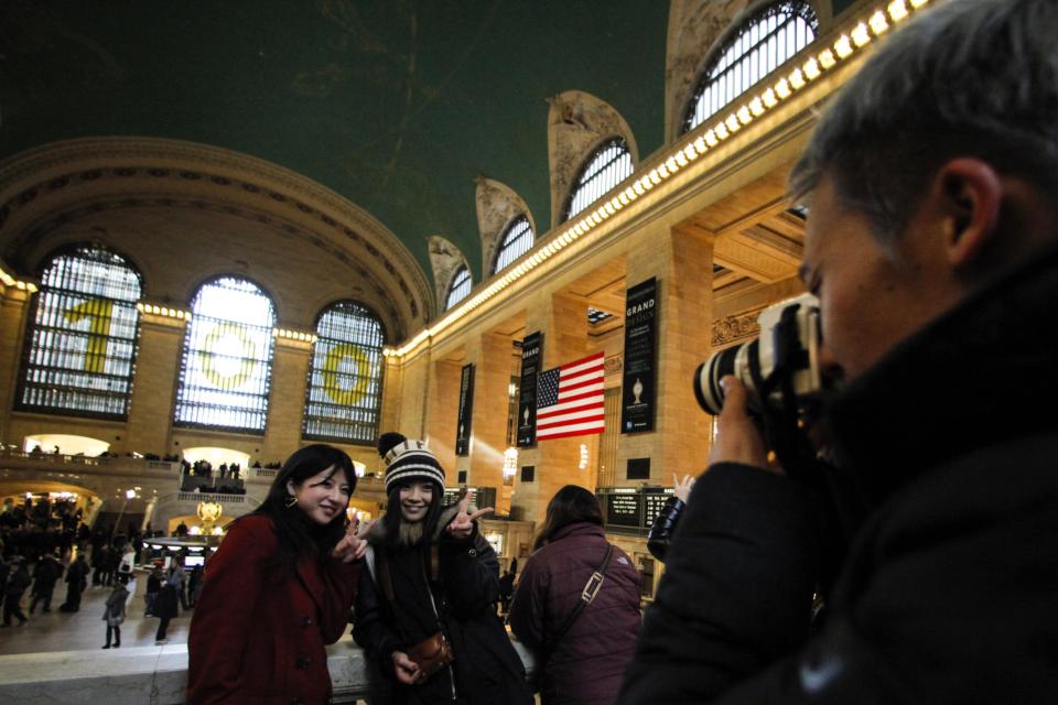 Tourists pose for a picture inside Grand Central Station in New York, February 2, 2013. Grand Central Terminal, the doyenne of American train stations, is celebrating its 100th birthday. Opened on February 2, 1913, the iconic New York landmark with its Beaux-Arts facade is an architectural gem, and still one of America's greatest transportation hubs. (REUTERS/Eduardo Munoz)