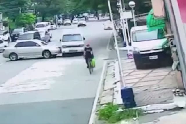 Lucky cyclist just inches away from being crushed by overturned minivan in the Philippines