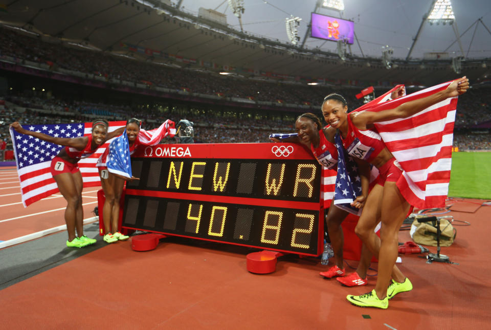 Carmelita Jeter of the United States, Bianca Knight of the United States, Allyson Felix of the United States and Tianna Madison of the United States celebrate next to the clock after winning gold and setting a new world record of 40.82 afterthe Women's 4 x 100m Relay Final on Day 14 of the London 2012 Olympic Games at Olympic Stadium on August 10, 2012 in London, England. (Photo by Michael Steele/Getty Images)