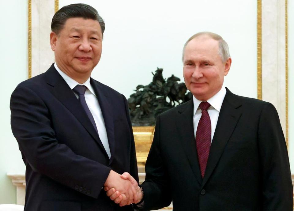 Chinese President Xi Jinping and Russian President Vladimir Putin pose for a photo during their meeting at the Kremlin in Moscow