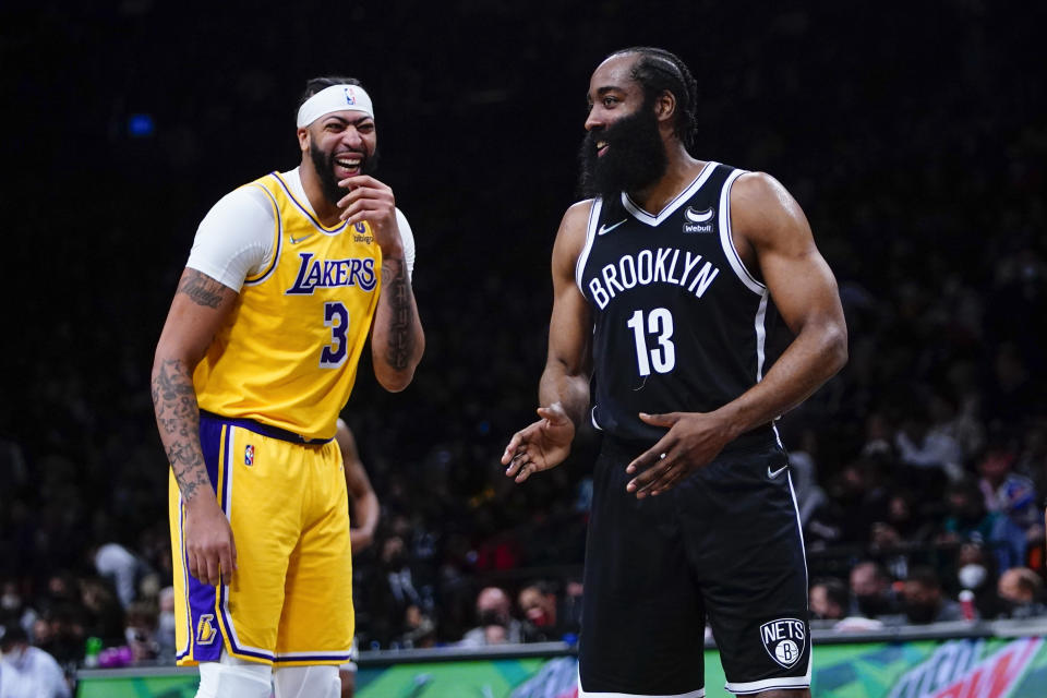 Los Angeles Lakers' Anthony Davis (3) laughs with Brooklyn Nets' James Harden (13) during the first half of an NBA basketball game Tuesday, Jan. 25, 2022 in New York. (AP Photo/Frank Franklin II)