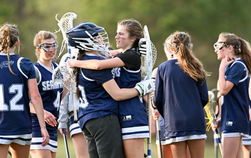 Cape Cod Academy goalie Flynn Kayajan and Tilly Crosby celebrate with their team after defeating St. John Paul II 17-11 in girls lacrosse
(Photo: Ron Schloerb/Cape Cod Times)