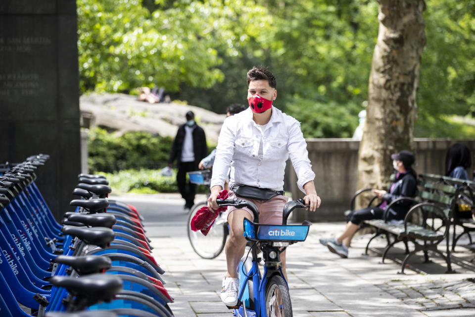 A man with a mask takes out a Citi Bike in Central Park on May 24, 2020 in New York. (Photo by Ira L. Black/Corbis via Getty Images)