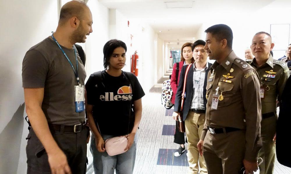 Saudi woman Rahaf Mohammed al-Qanun (second left) is escorted by a Thai immigration officer and UNHCR officials at the Suvarnabhumi international airport in Bangkok on Monday.