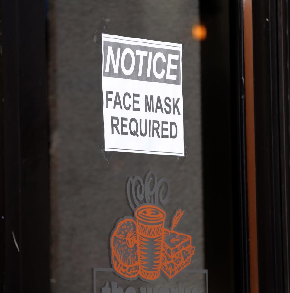 The Works Cafe in Portsmouth has a sign on its door requiring masks, as seen Monday, Jan. 10, 2022.