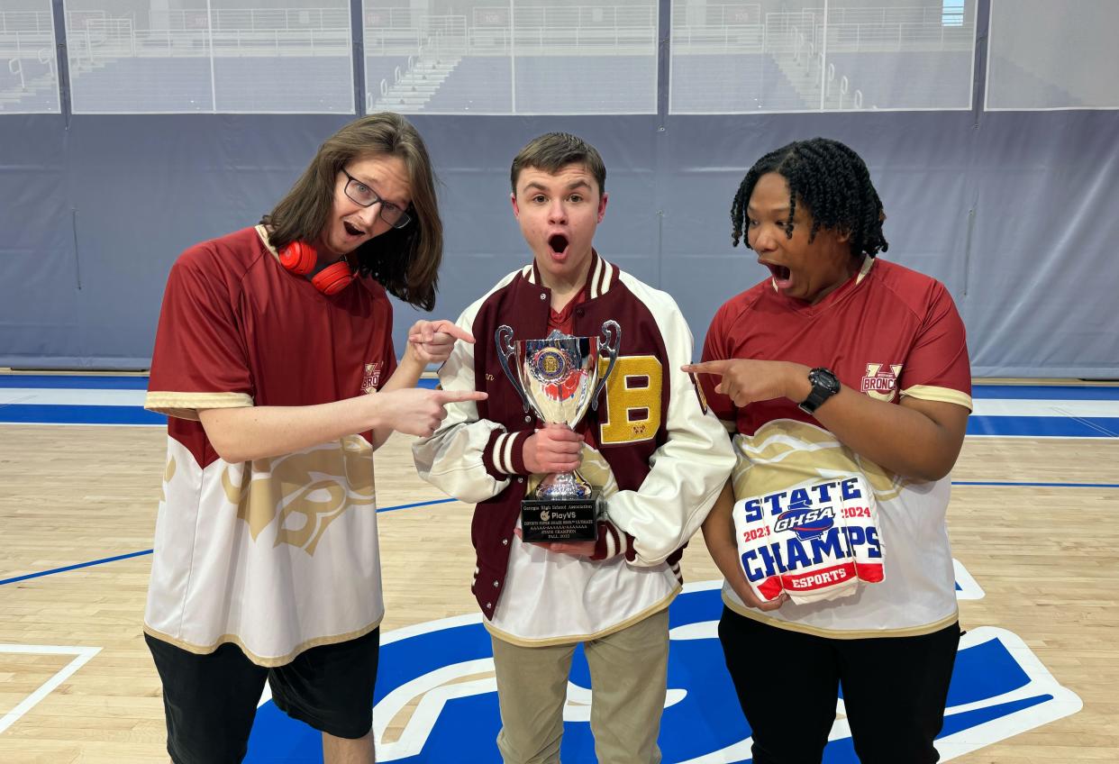 Brookwood High School players celebrate their victory in "Super Smash Bros. Ultimate" at the GHSA State Esports Championships at the University of West Georgia in Carrollton on Friday, Dec. 15, 2023.