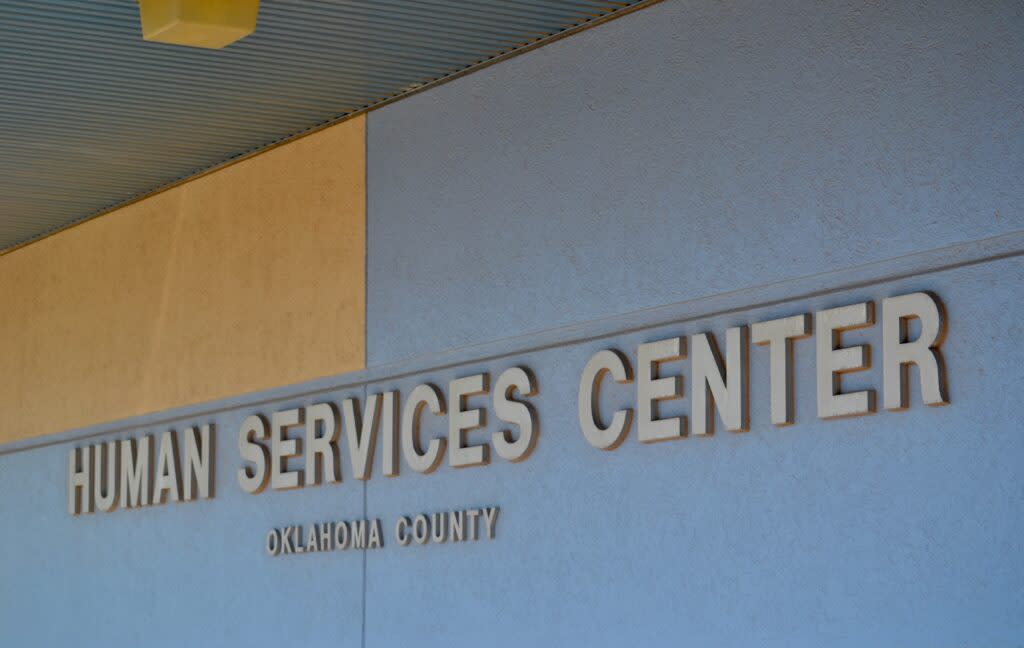 Text on a building marks an Oklahoma DHS office in Oklahoma County